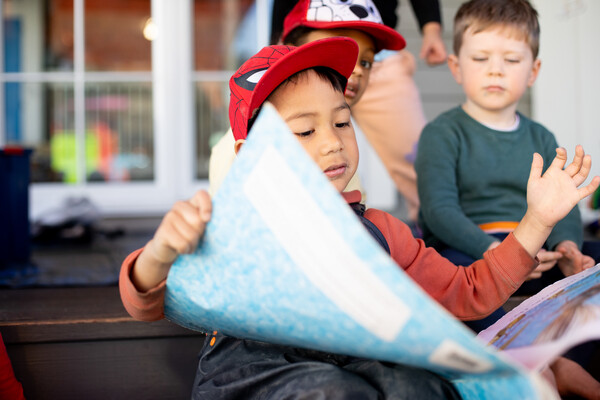 Child reading a large book.